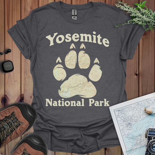 Gray t-shirt with Yosemite National Park design on a wooden surface with hiking gear.